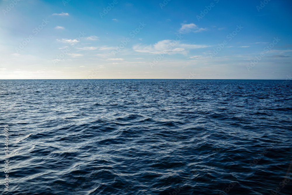 Bright blue Ocean water ripples background on a sunny day. Clean water consumption and natural resources Bright blue Ocean water ripples background on a sunny day. Clean water consumption and natural resources