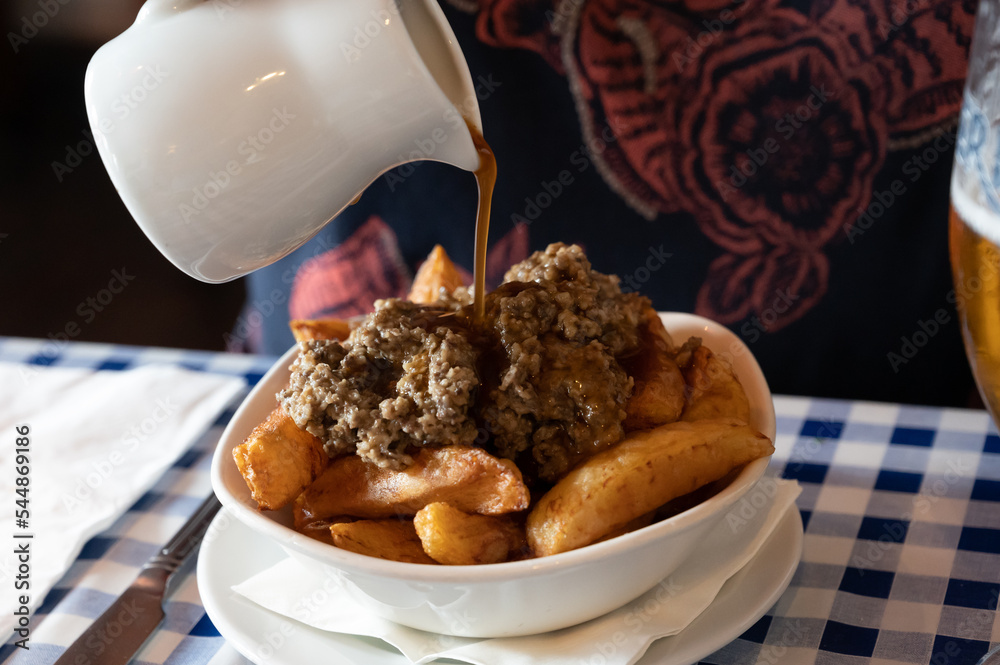 Scottish traditional snack food, hand cut potato chips topped with