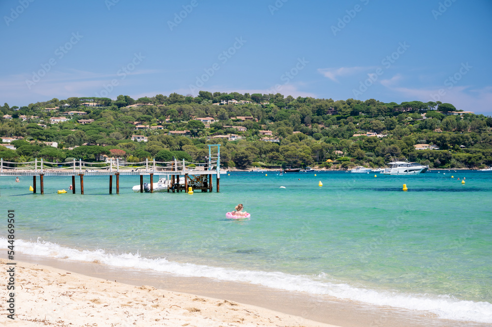 Obraz premium Crystal clear blue water of legendary Pampelonne beach near Saint-Tropez, summer vacation on white sandy beaches of French Riviera, France