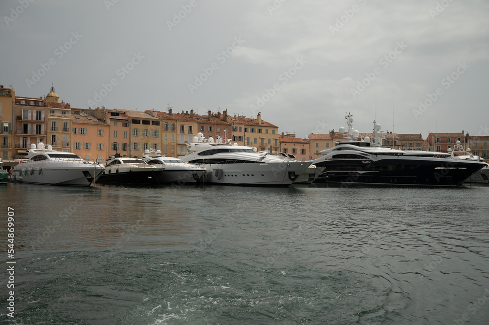 Fototapeta premium Colorful houses and yachts in Port of Saint Tropez, village on Mediterranean sea with yacht harbour, Provence, France