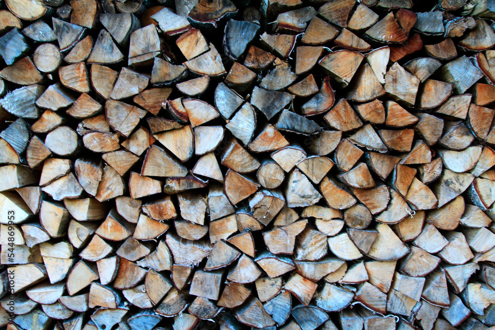 A lot of stacked woodpile, firewood. Selective focus. Background, texture A lot of stacked woodpile, firewood. Selective focus. Background, texture