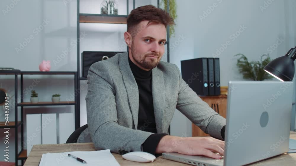 Businessman in suit working on laptop computer shakes finger and saying no, be careful, scolding and giving advice to avoid danger mistake, disapproval sign at office. Confident serious freelancer man Businessman in suit working on laptop computer shakes finger and saying no, be careful, scolding and giving advice to avoid danger mistake, disapproval sign at office. Confident serious freelancer man