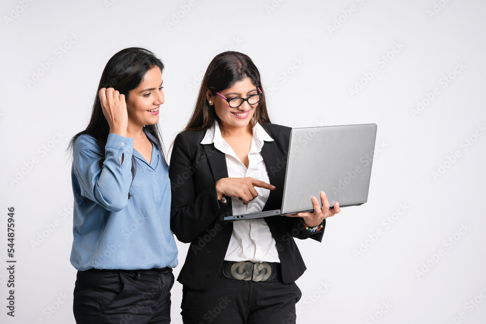 Two Young indian businesswoman watching some detail in laptop. Two Young indian businesswoman watching some detail in laptop.