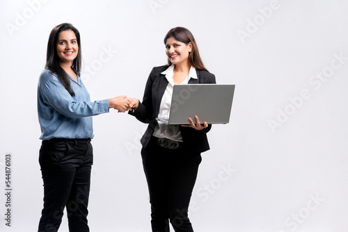Two indian Businesswomen Shaking Hands on white background.