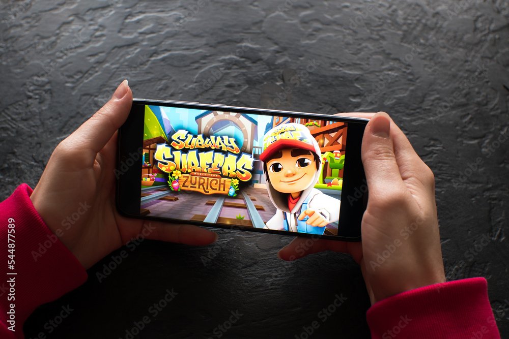 LVIV, UKRAINE - November 08, 2022 : Playing mobile game Subway Surfers on  modern smartphone. Stock Photo