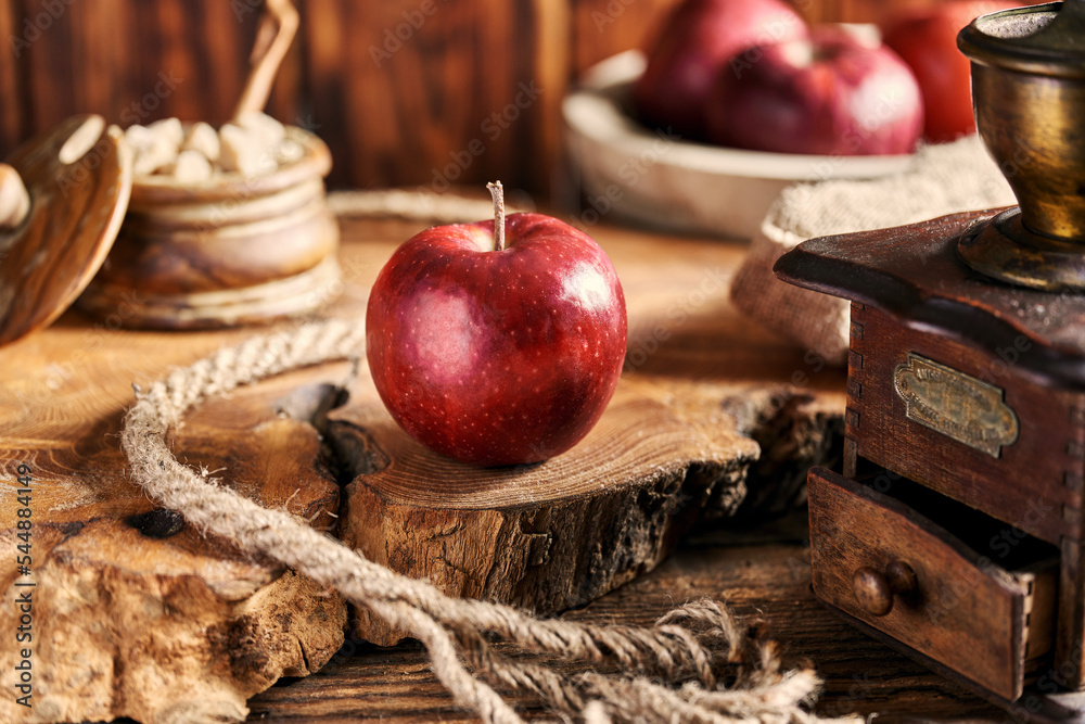 Red apple on an old wooden table top.
