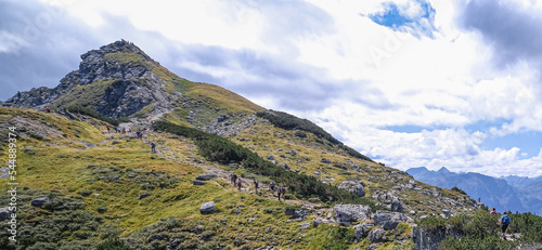 Hikers on the trail from Gasselhohe mountain to Rippetegg mountain, Rieteralm, Schladming, Dachstein, Styria, Austria photo