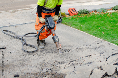 Tablou pe pânză Builder breaking asphalt with hydraulic jackhammer