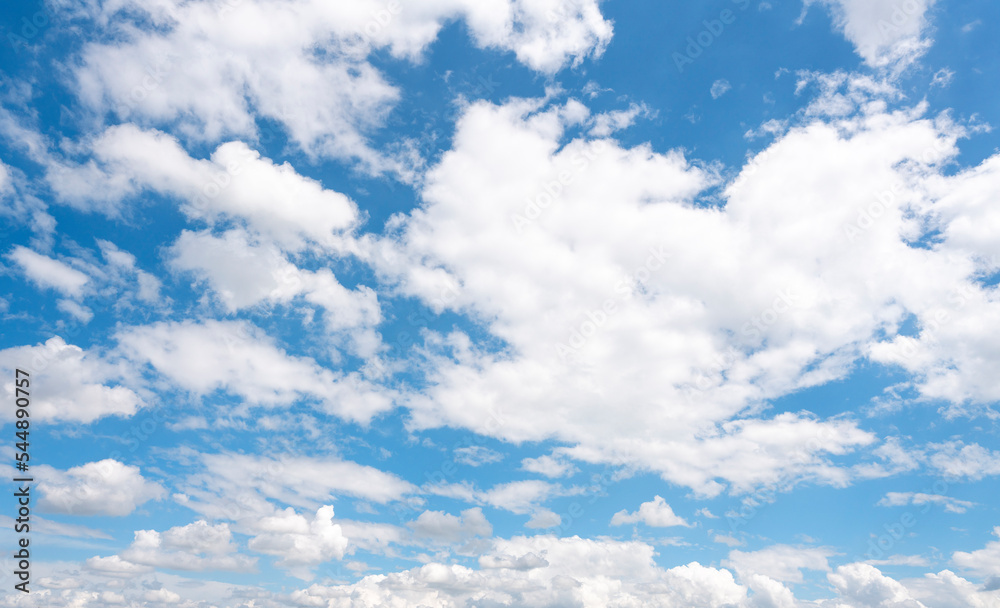 white cirrus, feathery clouds against spring bright blue cloudy sky on sunny day in England white cirrus, feathery clouds against spring bright blue cloudy sky on sunny day in England