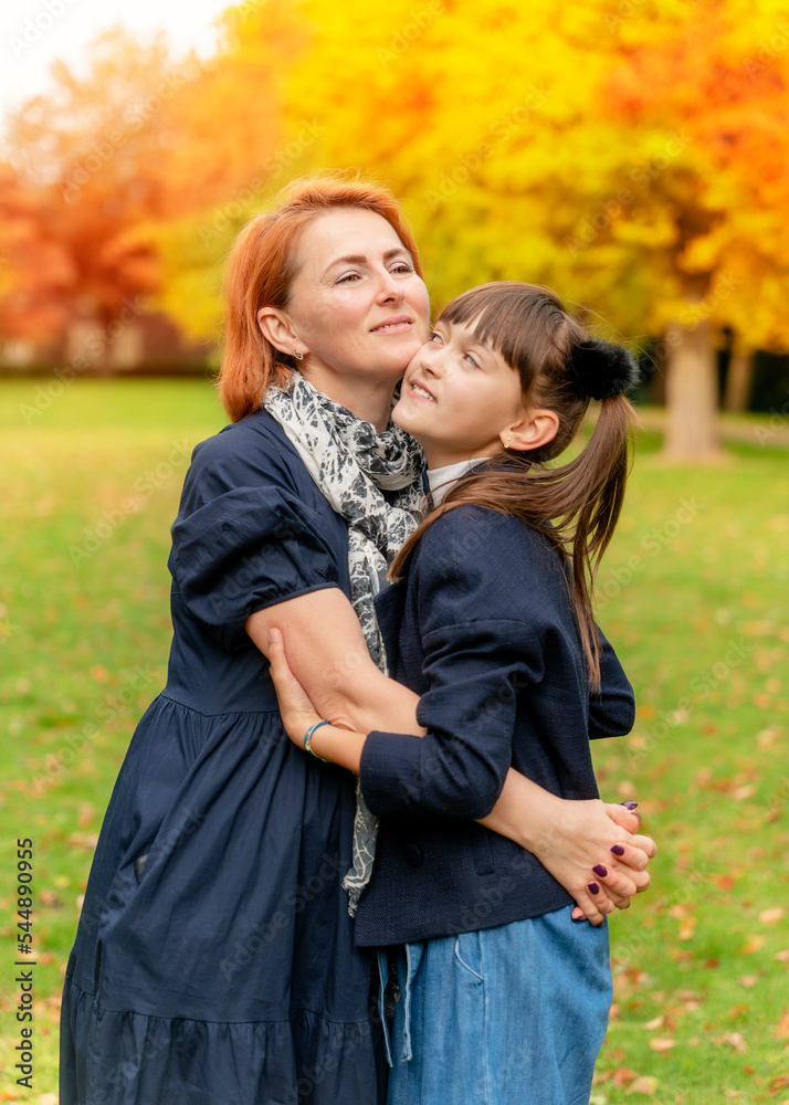 daughter and mother having fun in autumn park daughter and mother having fun in autumn park