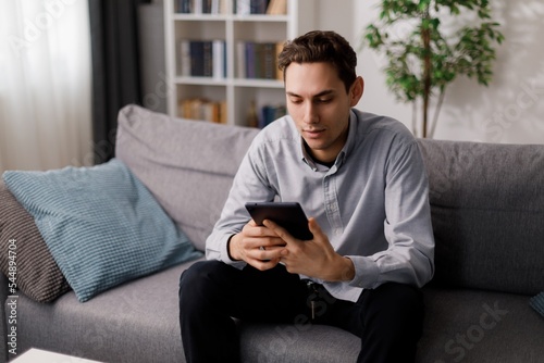 Man with tablet on couch