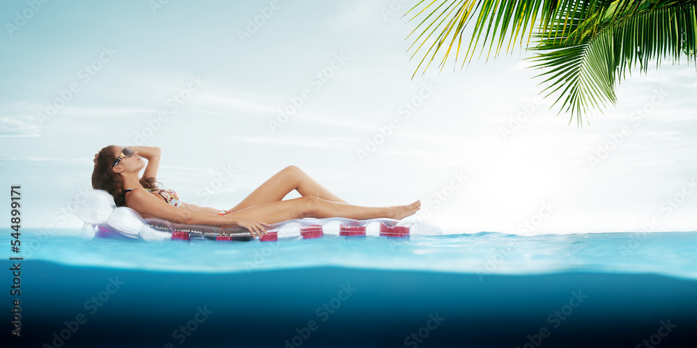 View of nice young girl is hanging on air mattress in tropic environment
