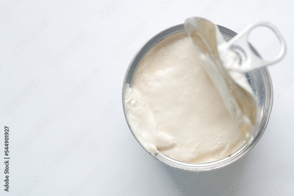 top view of milk cream in a tin container on table top view of milk cream in a tin container on table