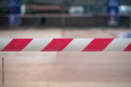 Closed area with brightly barricade tape in white and red. © wedninth