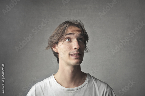 portrait of young man while making a grimace