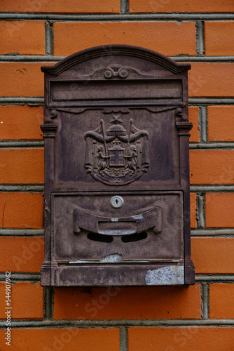 Old vintage mailbox on brick wall.