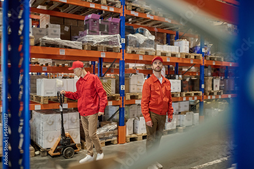 Two men working in the storage area