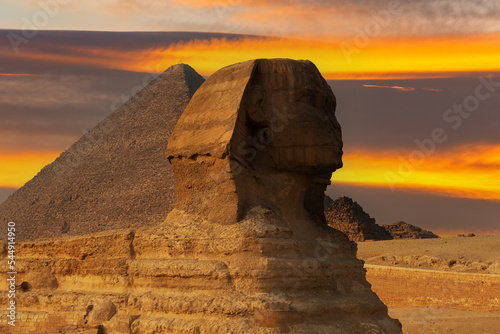 Sculpture of the Sphinx against the background of the Priamis of Cheops on the Giza plateau in Egypt against the background of the picturesque sky