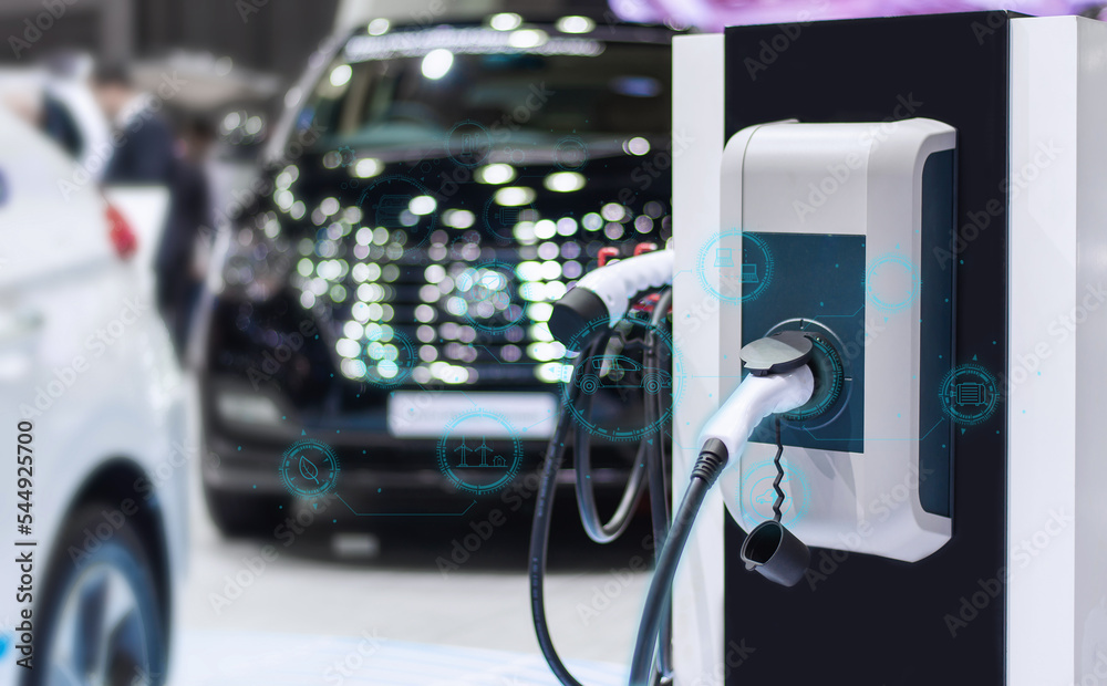 Plugging an electric car's power cable car charging station booth with