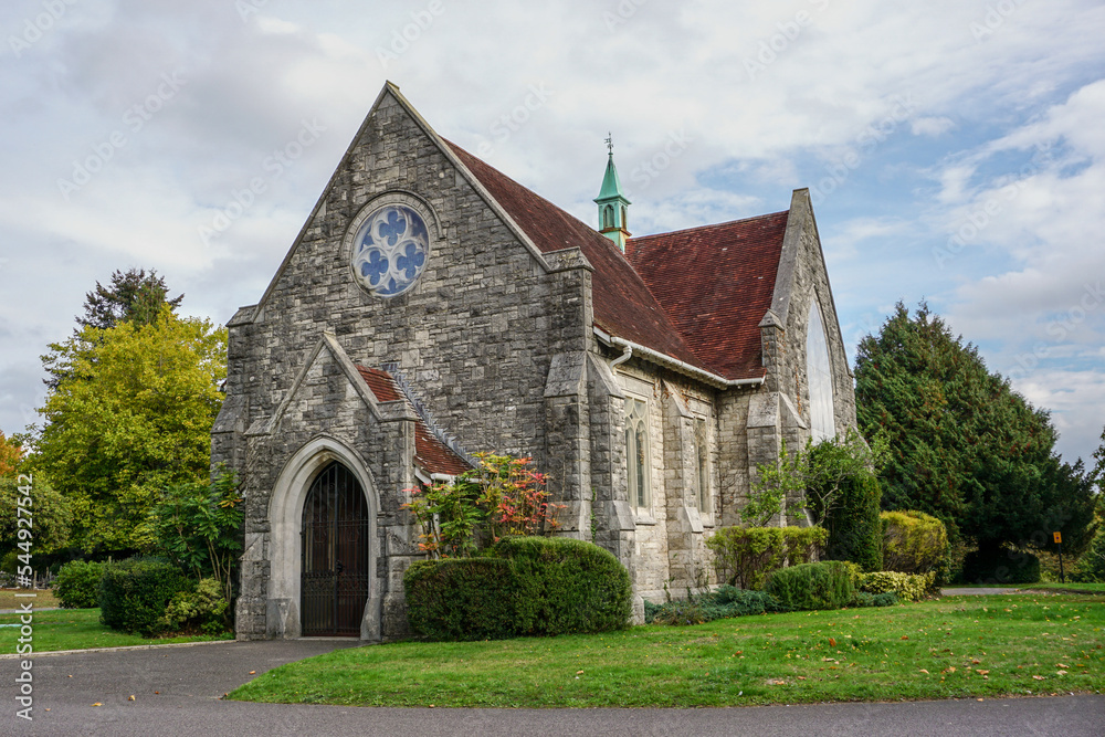 pretty small chapel in picturesque setting. Religious building exterior. Quaint English church façade pretty small chapel in picturesque setting. Religious building exterior. Quaint English church façade