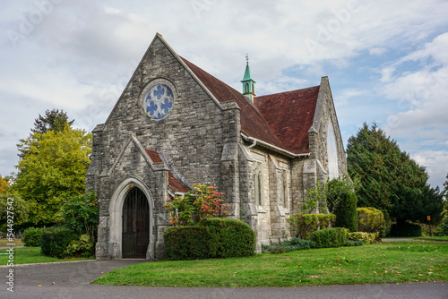 pretty small chapel in picturesque setting. Religious building exterior. Quaint English church façade 