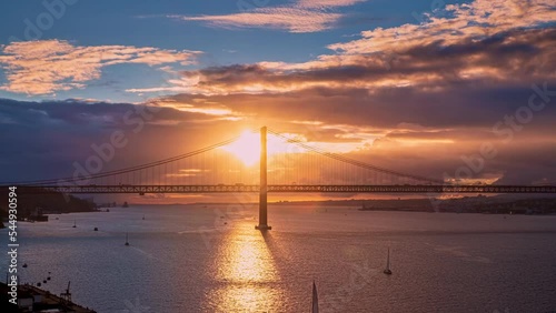 Beautiful sunset over Bridge of 25th April, Lisbon, Portugal. Famous photo