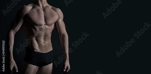 muscular bodybuilder isolated on black background. muscular bodybuilder on banner with copy space.