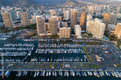 the City of Honolulu Marina, O'ahu, Hawaii. Tall buildings with marina below full of boats. 