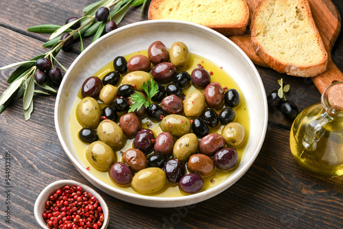 healthy food salad different green and black olives with olive oil and herbs