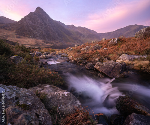 Tryfan at sunrise - beautiful mountain in Snowdonia with stream running through foreground.  Pinks and pastel colours