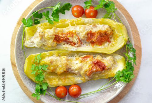 Stuffed zucchini of minced chicken, turkey meat. Zucchini baked in the oven with cheese. Healthy dinner for the whole family