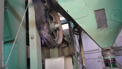 Rice mill plant machine drived by old pulley and belt rotation photo
