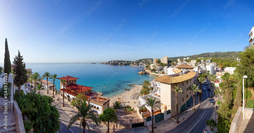 Sandy Beach, Colorful Blue Sea Water and Residential Homes on Mediterranean Coast. Palma, Balearic Islands, Spain. Aerial Panorama