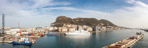 City Buildings, Port and Mountain by the Sea. Cloudy Sunny Sky. Gibraltar, United Kingdom. Panorama