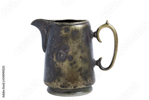 Vintage brass creamer with dents and scratches isolated on a white background.