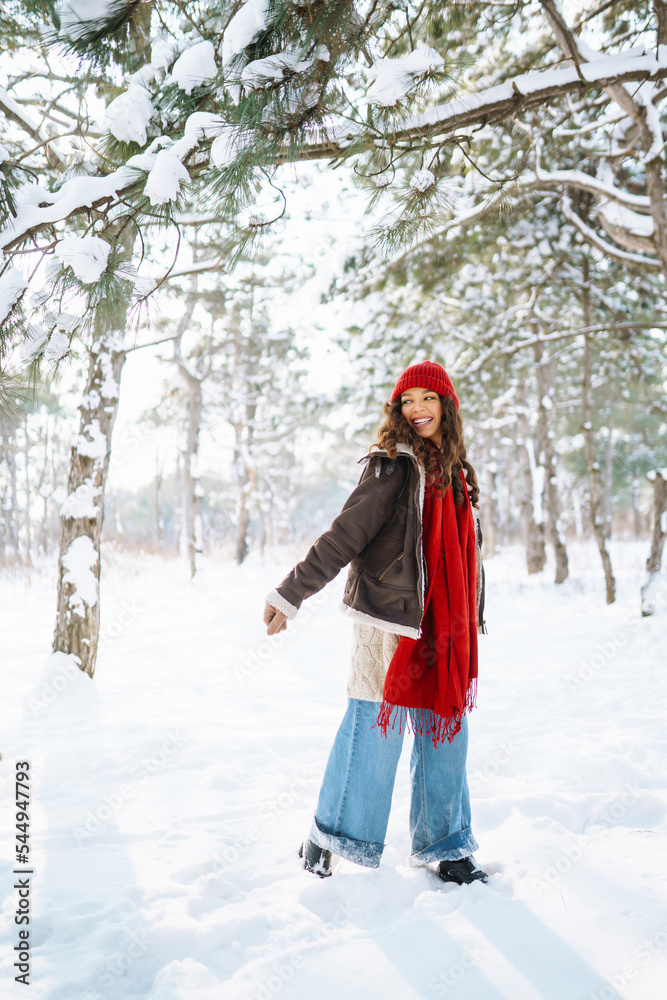 Happy woman standing among snowy trees and enjoying first snow. Holidays, rest, travel concept Happy woman standing among snowy trees and enjoying first snow. Holidays, rest, travel concept