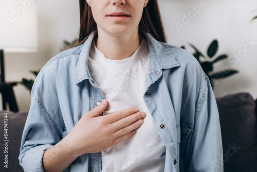 Fotografie Cropped shot unhealthy sad caucasian woman having or symptomatic reflux acids, Gastroesophageal reflux disease, Because the esophageal sphincter separates the esophagus