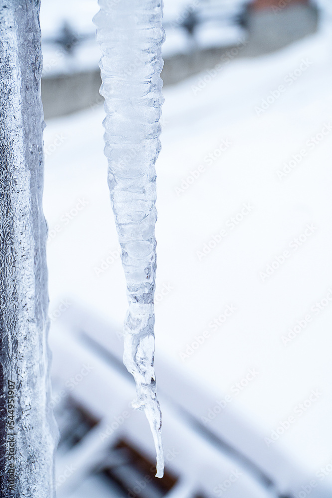 A large icicle hangs from the roof.