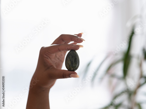 Close-up of woman holding yoni egg photo