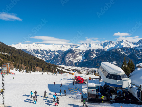 Slope view with funicular and snow groomer in winter in resort Ladis, Fiss, Serfaus in ski resort in Tyrol.