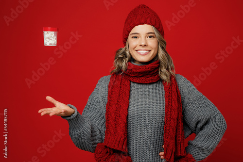 Fotografiet Young fun smiling happy woman wear grey sweater scarf hat hold toss up jar with