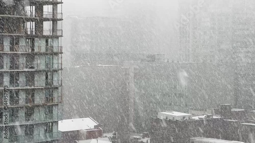 Buildings in heavy snowfall during winter day