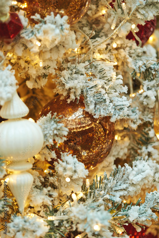 Various decorations on a snowy Christmas tree Various decorations on a snowy Christmas tree