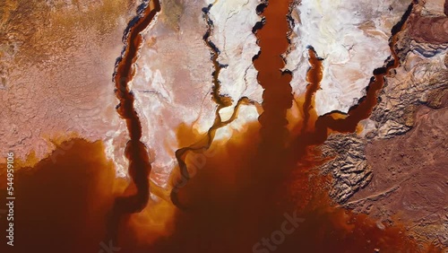 Aerial drone view of Mining activity in Minas de Riotinto in Spain. Polluted lake, red color of water. Apocalypse scenery. Extractivism. Mining village in Andalusia. Destruction of nature.