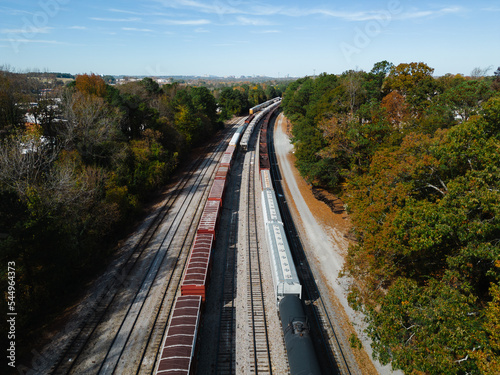 Aerial of train on tracks in autumn