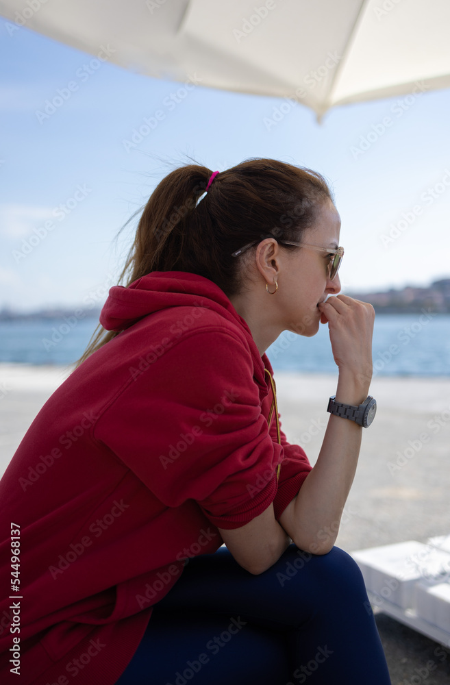 Woman biting her nails. She has onychophagia. 