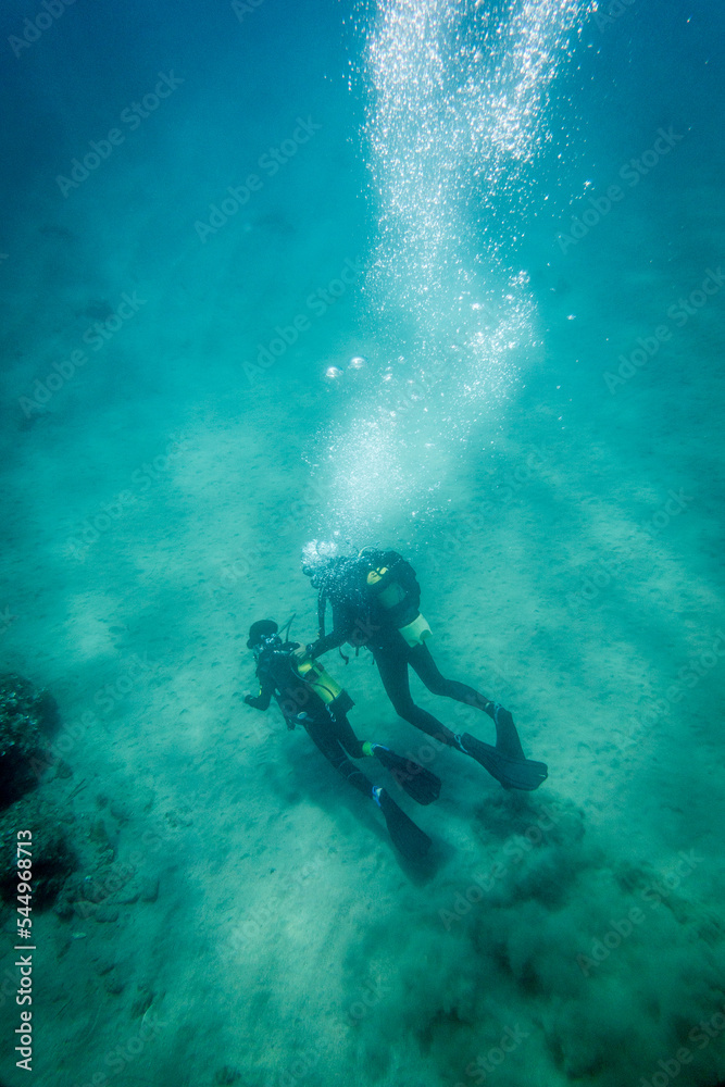 Father and son swimming in deep sea