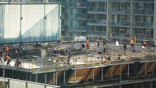 Workers at top of building at construction site