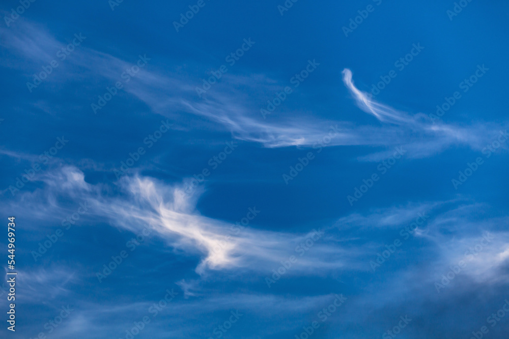 Blue sky covered by soft white clouds