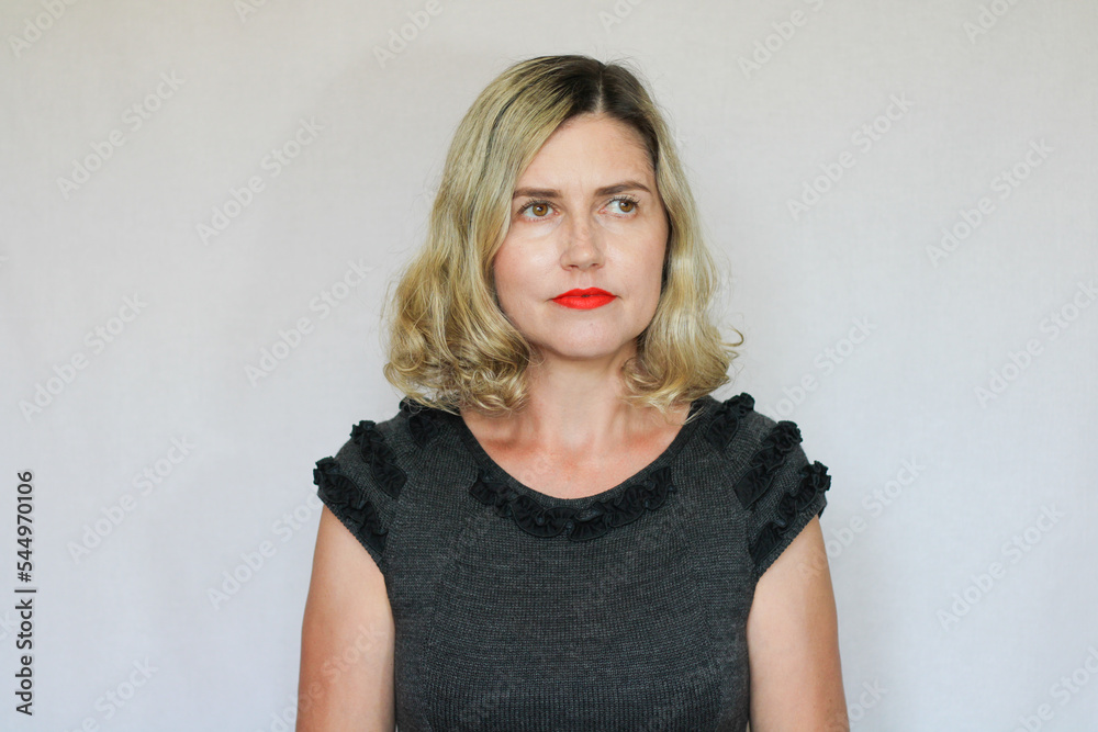 Beautiful middle-aged blond woman on a white background Beautiful middle-aged blond woman on a white background